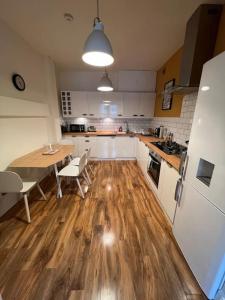 a kitchen with a wooden floor and a table with chairs at Gorgeous home in Hebden Bridge in Hebden Bridge