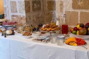 a table with a buffet of fruit and other foods at Dimore Briganti in Gallipoli