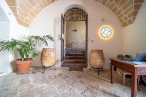 a room with a door and a table and a desk at Dimore Briganti in Gallipoli