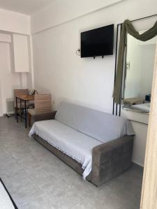 a bedroom with a bed and a tv on the wall at Mani Spot in Areopoli