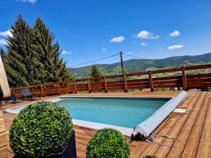 a swimming pool on top of a wooden deck at ATPeak Lodge Maison de Montagne d'exception in Xonrupt-Longemer