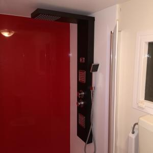 a red door in a bathroom with a shower at Camping Park Soline - Rose PB -Mobile Home in Biograd na Moru