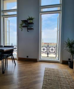 a living room with a table and a large window at Imperial Suites Heart Of Margate! sleeps 6 in Kent