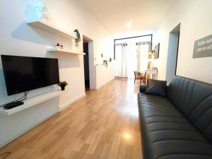 a living room with a couch and a flat screen tv at Casa Cristina Beach in Marina di Ragusa