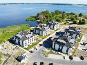 an aerial view of a row of houses next to the water at Baltic Sea Flair: Just steps from the sea in Dziwnów
