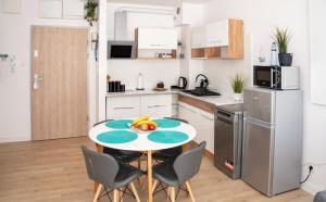 a kitchen with a table with fruit on it at Baltic Sea Flair: Just steps from the sea in Dziwnów