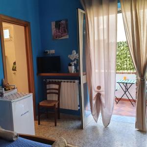 a bedroom with a door open to a patio at La capannina cilento cam 10 in San Marco di Castellabate