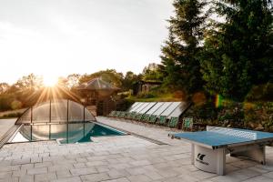 a swimming pool with a table and a tent at Bieszczadzka Bania in Lesko
