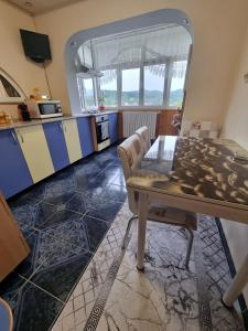 a kitchen with a table and chairs in a room at Emily Residence in Curtea de Argeş
