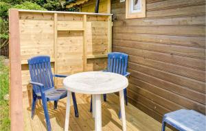 dwa niebieskie krzesła i stół na drewnianym tarasie w obiekcie Lovely Home In Kleppe With Kitchen w mieście Bore