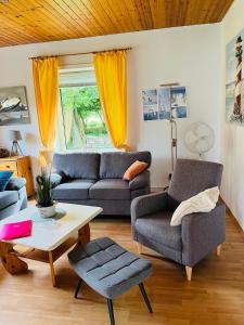 a living room with two couches and a coffee table at Ferienwohnanlage Sturmhöhe in Welt