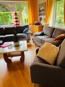 a living room with two couches and a coffee table at Ferienwohnanlage Sturmhöhe in Welt