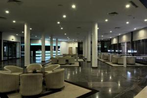 a lobby with chairs and tables in a building at Andalucia Bizerte plage et piscine in Bizerte