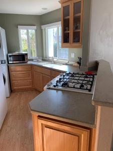 a kitchen with a stove and a counter top at Cozy Guesthouse- Individual Unit Private & Relaxing in Concord