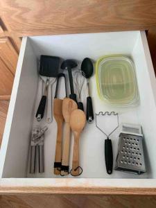 a drawer filled with various kitchen utensils and a container at Cozy Guesthouse- Individual Unit Private & Relaxing in Concord