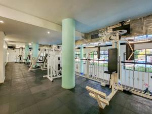 a gym with rows of treadmills and machines at Heated pool, Private garden, self check-in in Cape Town