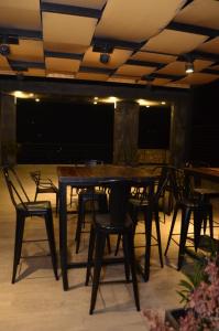 a table and chairs on a patio at night at Jade Barrio Sur A Estrenar by Citrino Aparts in San Miguel de Tucumán