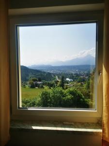 a window with a view of the mountains at Panoramablick Exklusiv in Villach