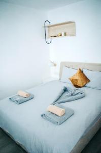 a bed with blue blankets and towels on it at Premium Sun Apartment in Vokolidha