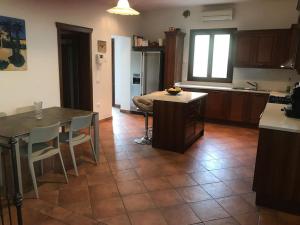 a kitchen with a table and chairs and a table and a kitchen with a counter at Villa Parisi, Fano, Marche, Italian Villa in Fano