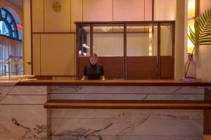 a person sitting at a counter in a room at The Evelyn NoMad in New York