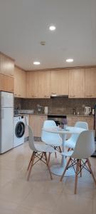 a kitchen with a table and chairs in a kitchen at Los Boliches Apartamentos Mediterraneo Real in Fuengirola