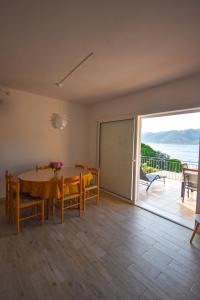 a dining room with a table and a view of the ocean at Apartman AnTe in Korčula