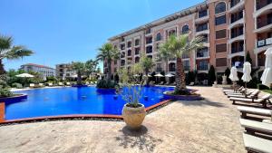 a large swimming pool in front of a building at Bratanov Cascadas Ravda in Ravda