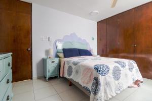 1 dormitorio con 1 cama con edredón azul y blanco en Hostal en El Centro LaKiwa en Mazatlán