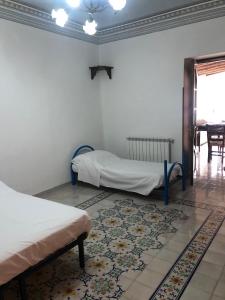 a room with two beds and a rug at Isola - LIPARI centro storico in Lipari
