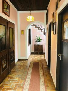 an entry hallway with an archway and a staircase at Holmes Café & Pension in Engelhartszell