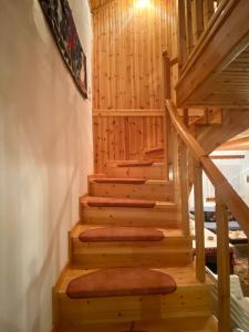 a staircase in a log cabin with wooden steps at Maroulas House in Chrysomiléa