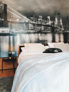 a bedroom with two beds and a view of a city at Apartment Volosko View in Opatija