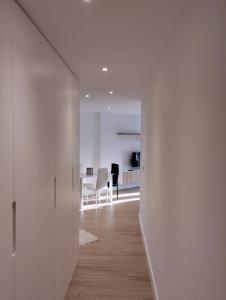 a hallway with white walls and a dining room at Apartamento Mar de la Concha in Vilagarcia de Arousa