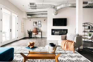 a living room with a couch and a table at Modern Industrial Loft - Center of RiNo Art District in Denver