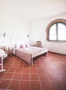切奇納的住宿－Relais Casale Il Poggetto - OLIVO 1，卧室配有一张床,铺有红色瓷砖地板。