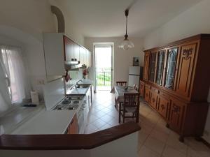 a kitchen with white counter tops and a kitchen with a table at Al VIgneto in Sestri Levante