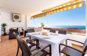 a dining room with a table and chairs and the ocean at Lovely Apartment In Mlaga With Kitchenette in Málaga