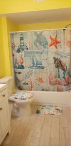 a bathroom with a toilet and a shower curtain at Old Wooden Bridge Resort & Marina in Big Pine Key