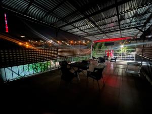 a group of chairs and tables in a building at night at Arm Hotel in Yerevan