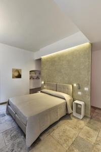 a bedroom with a large bed and a tv at Bed And Breakfast T57 in Bitonto