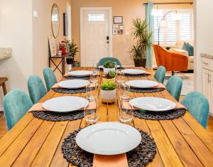 a dining room with a long wooden table and chairs at Colorful Home - Pool - Game Room - Basketball Court - BBQ & More in Fort Lauderdale