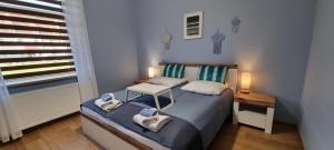 Łóżko lub łóżka w pokoju w obiekcie Apartament Cumulus