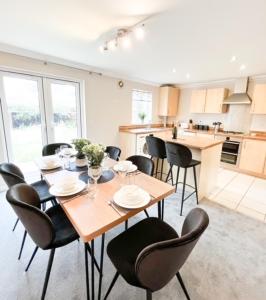 a dining room with a table and chairs in a kitchen at Turners Court in Melksham
