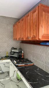 a kitchen with wooden cabinets and a counter top at house naim in Chefchaouen