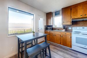 a kitchen with a table and a view of the ocean at Cape Cod Cottages - Unit 9 in Waldport