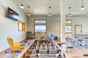 a room with a ping pong table and chairs at Cape Cod Cottages - Unit 9 in Waldport