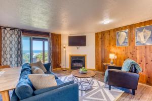 a living room with a blue couch and a fireplace at Cape Cod Cottages - Unit 8 in Waldport