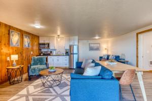a living room with a blue couch and a table at Cape Cod Cottages - Unit 8 in Waldport