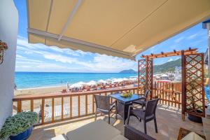 a balcony with a view of the beach at Elena's Seaside Apartments & Studios in Agios Gordios